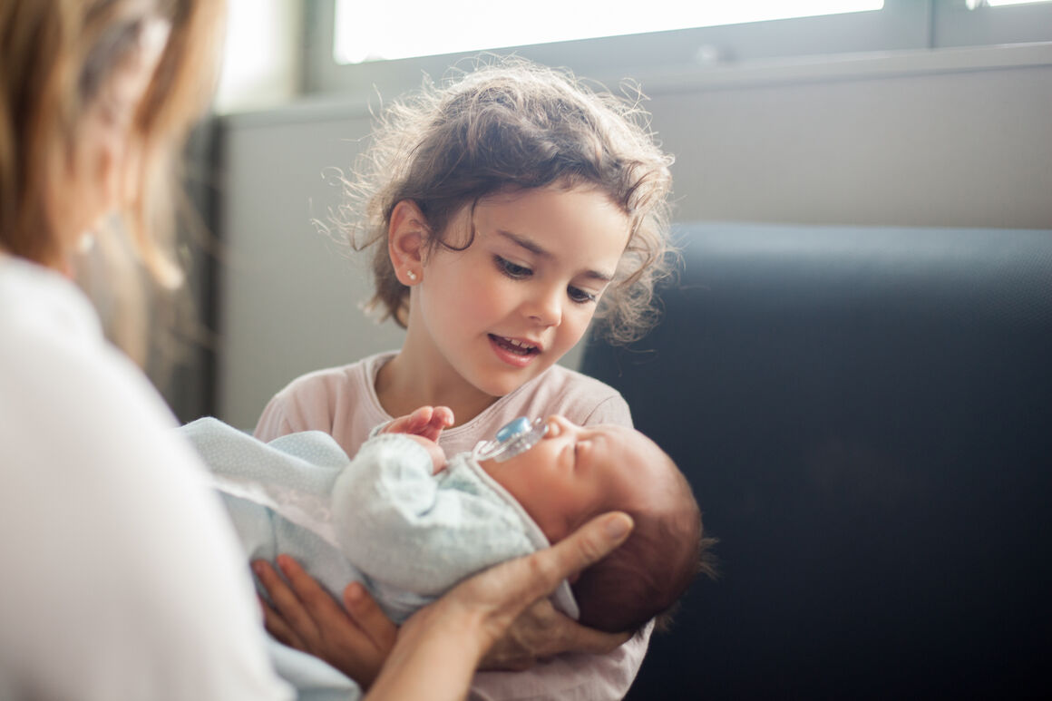 a girl with a newborn child